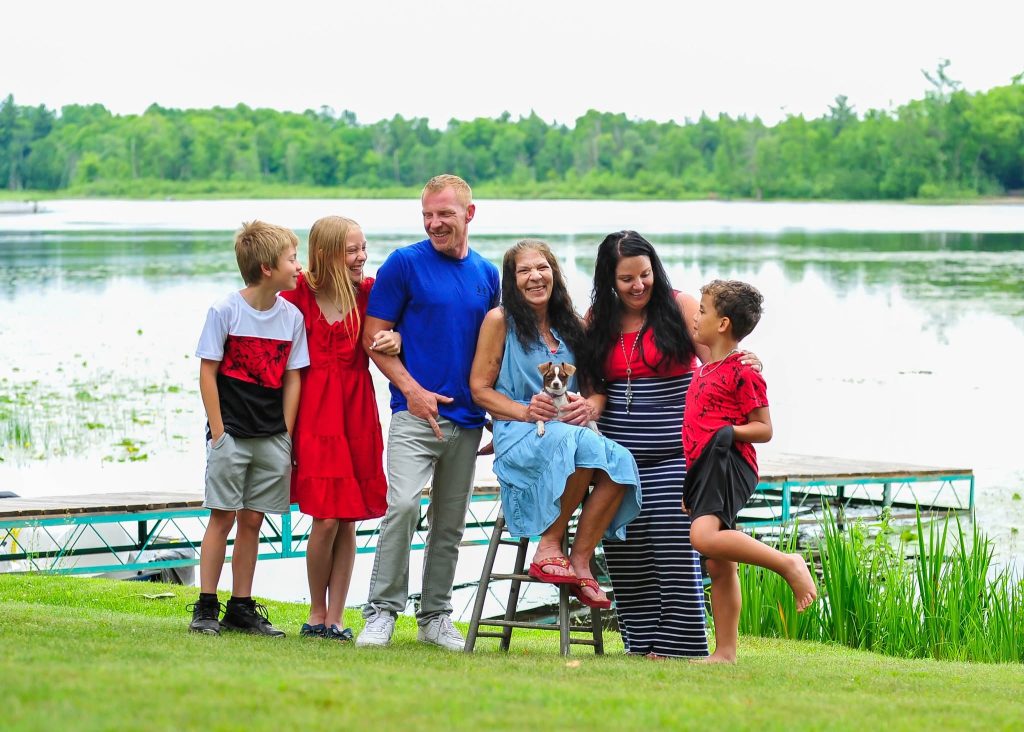 Family portrait in front of a lake and dock