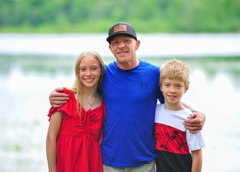 Dad with his daughter and son by the lake