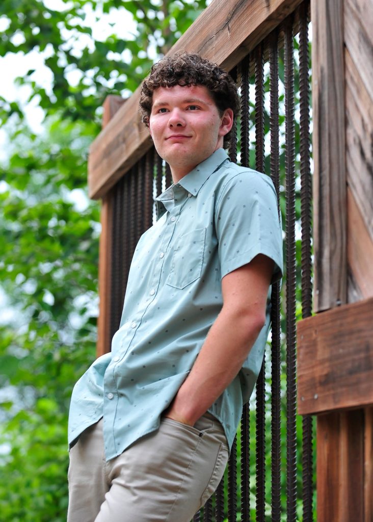 Senior leaning on a timber bridge