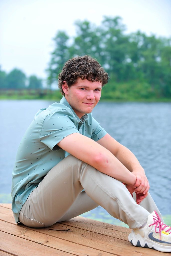 Senior sitting on a dock beside a lake